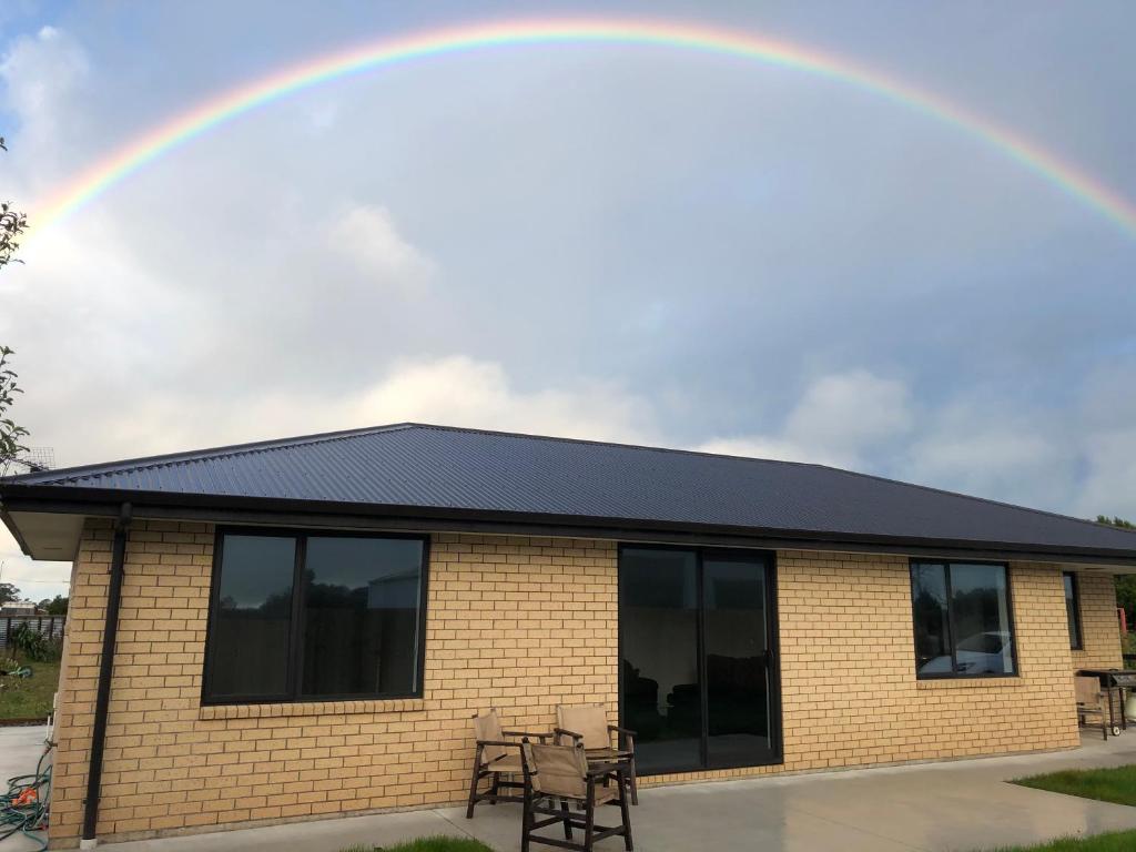 a rainbow in the sky above a building at The Drydock in Stratford