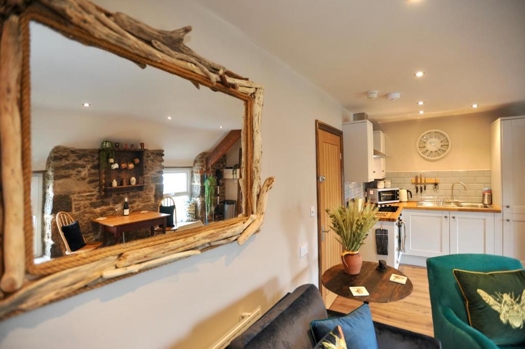 a mirror on the wall of a kitchen with a table at Beach View in Benllech