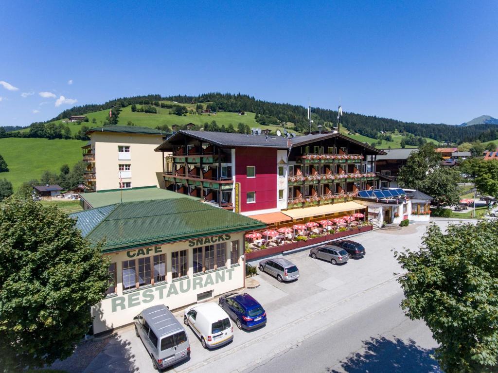 an aerial view of a town with cars parked in a parking lot at Hotel Harfenwirt in Niederau