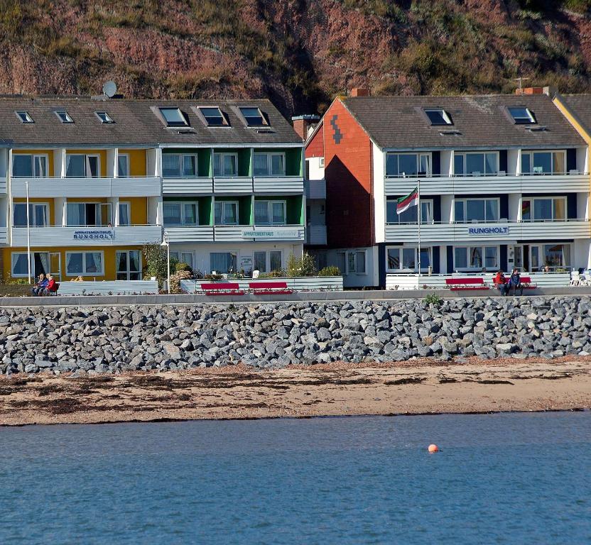 a building on the beach next to the water at Rungholt in Helgoland