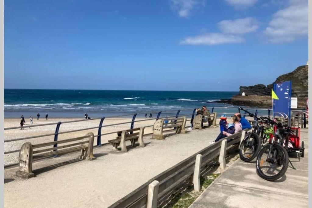 a group of people on a beach with bikes on a fence at ** Beautiful Scenery - Cyclists & Walkers Dream ** Log Burner ** Peaceful Hamlet ** in Redruth