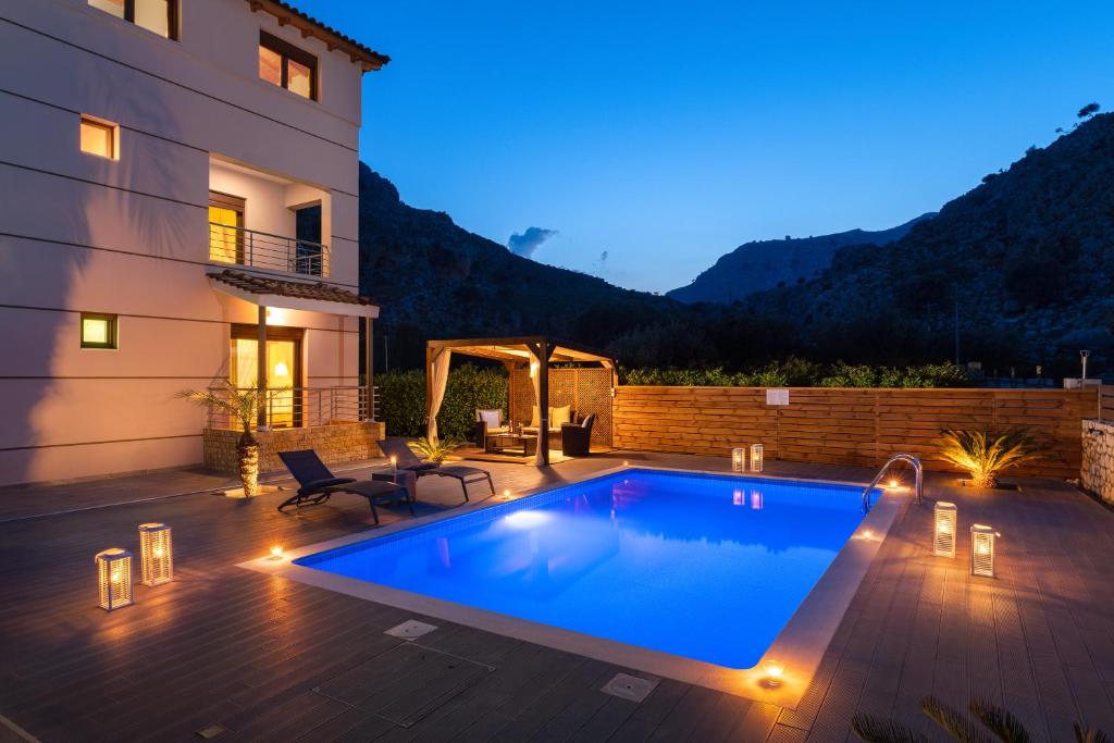 a swimming pool in a backyard with a house at Costa Costa Villa - Luxury villa in Kolymbia