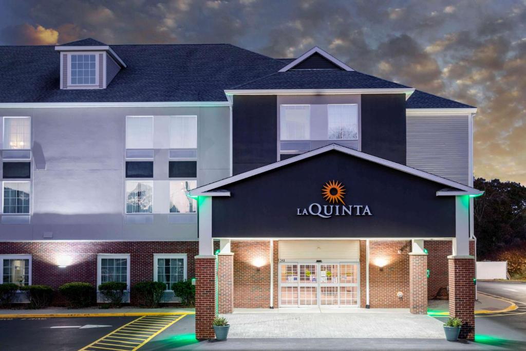 a building with a sign on the front of it at La Quinta by Wyndham Ely in Ely
