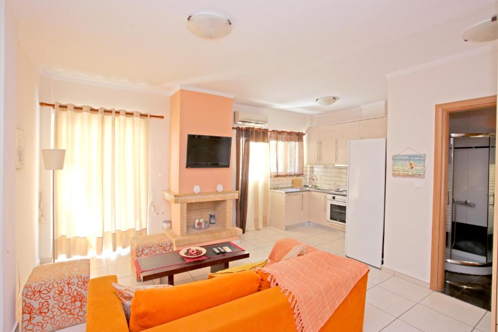 een woonkamer met een oranje bank en een keuken bij Apartment near the sea and the Athens airport , Artemida in Artemida