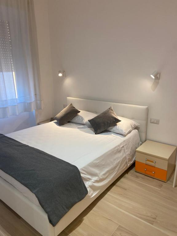 una camera da letto con un grande letto bianco con due cuscini di Casa vacanza Marily in centro, a 5 minuti dal mare ad Agropoli