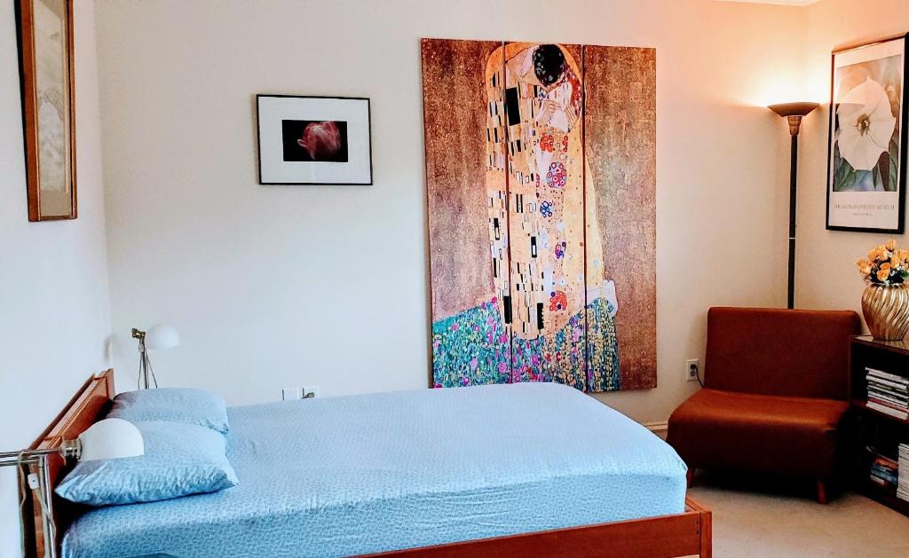 a bedroom with a blue bed and a chair at Free Parking on a Private St., Minutes to Georgetown, MedStar Hospital, Georgetown University and more in Washington, D.C.