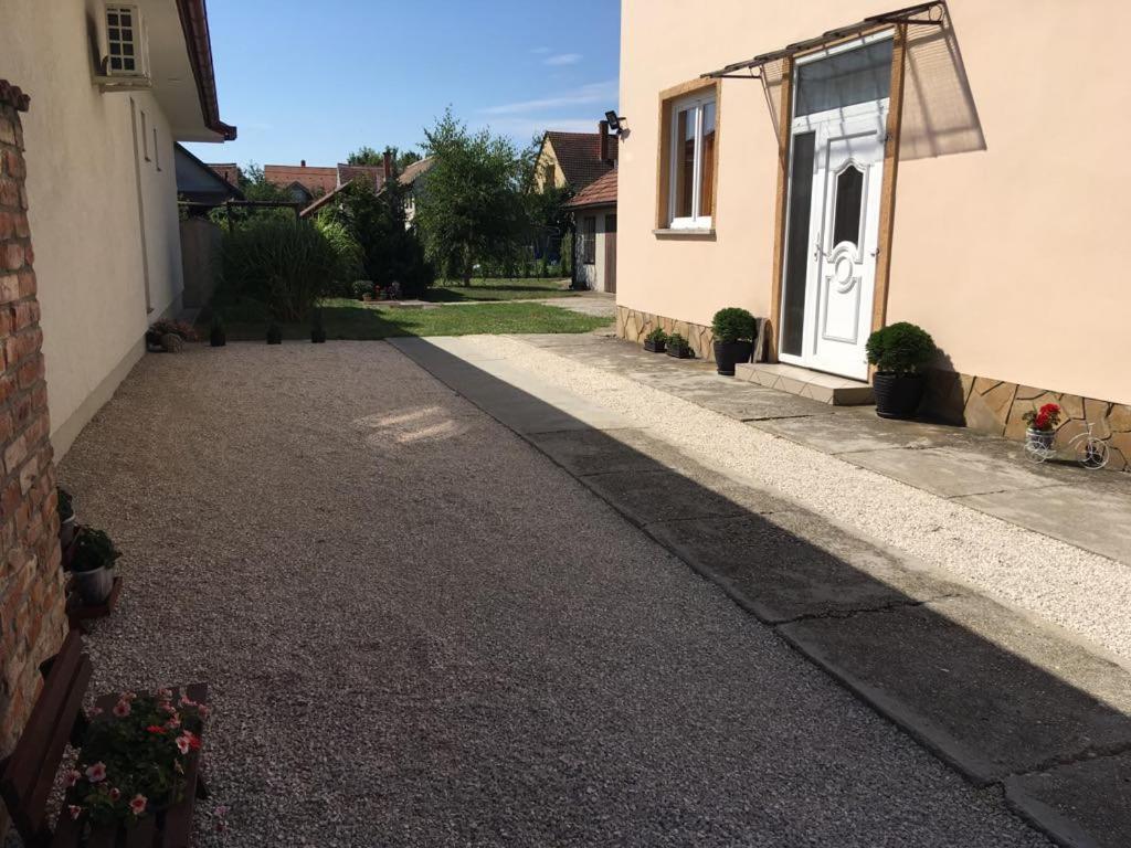 an empty driveway in front of a house at Adél Apartman in Sárvár