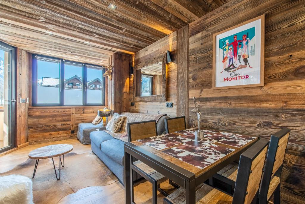 - un salon avec une table et un canapé dans l'établissement Le Prince des neiges, à Chamonix-Mont-Blanc