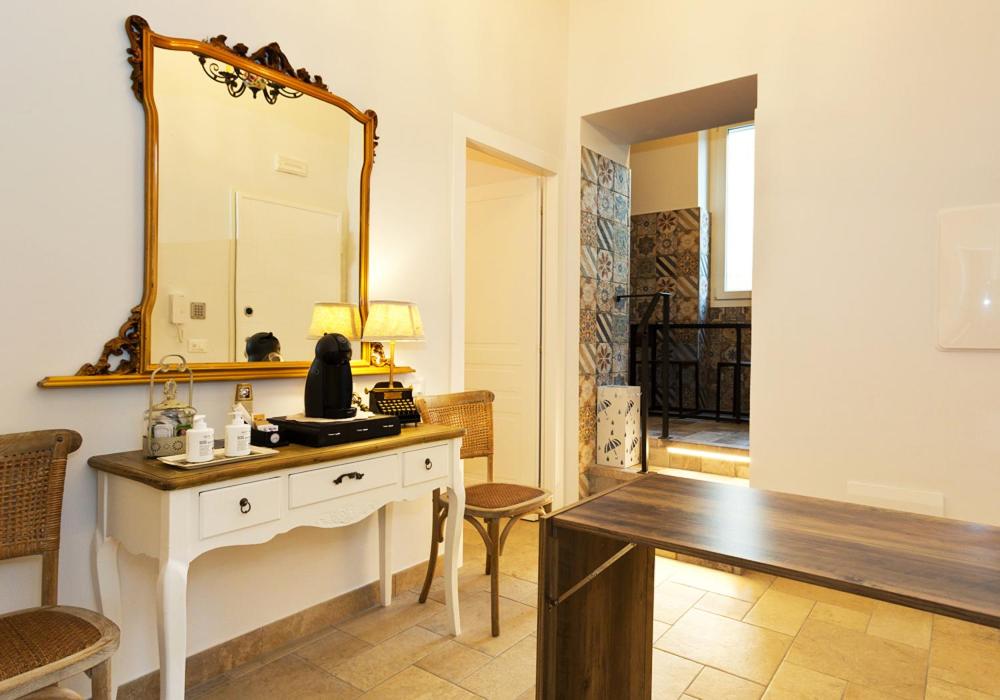 a bathroom with a vanity and a mirror on the wall at Casa Porta Marina in Ventimiglia