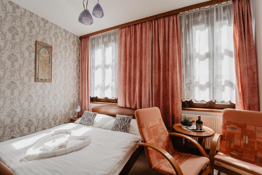 Postel nebo postele na pokoji v ubytování Hotel U Lípy