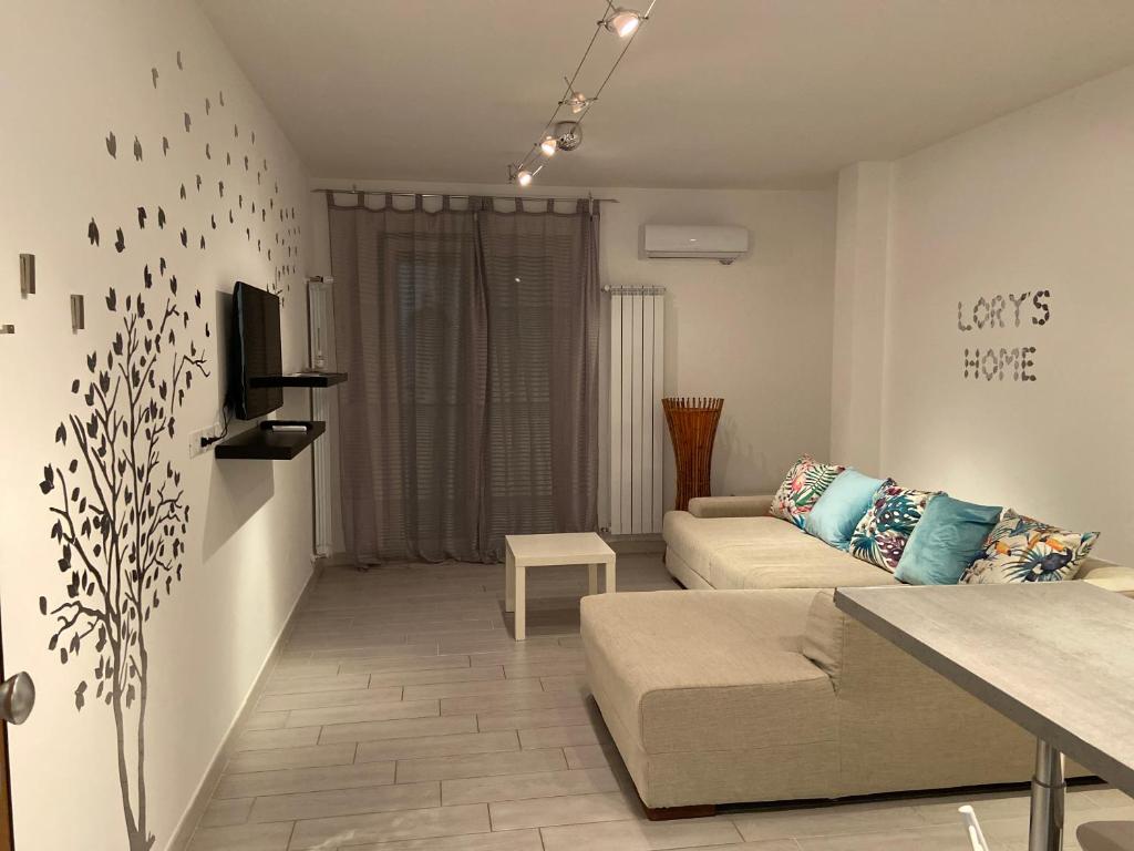 a living room with a couch and a tv at Bari Lory’s Home in Bari