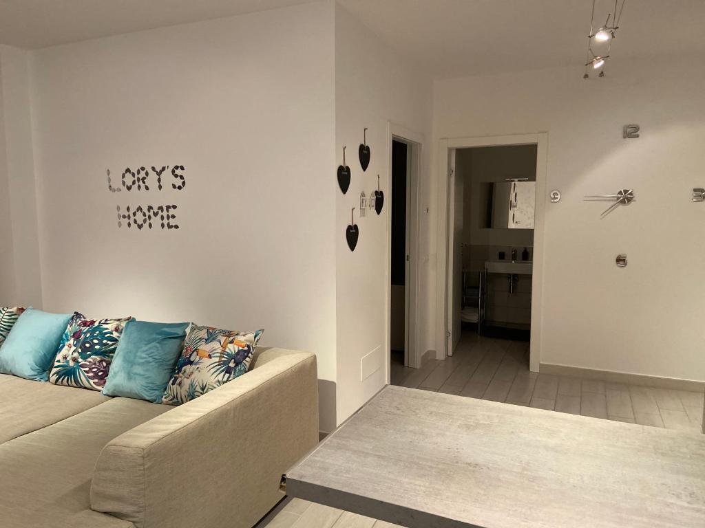 a living room with a couch and a room with a kitchen at Bari Lory’s Home in Bari