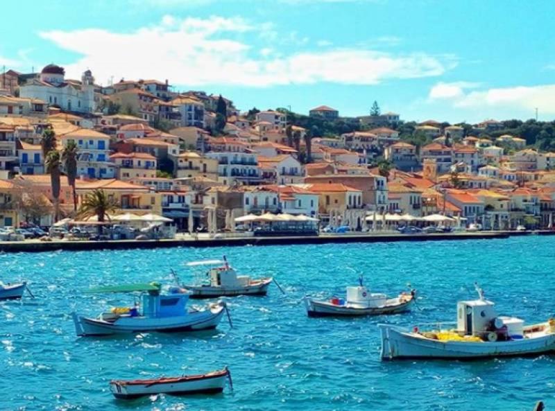 a group of boats in a body of water with buildings at Sea La Vie Apartment Koroni in Koroni