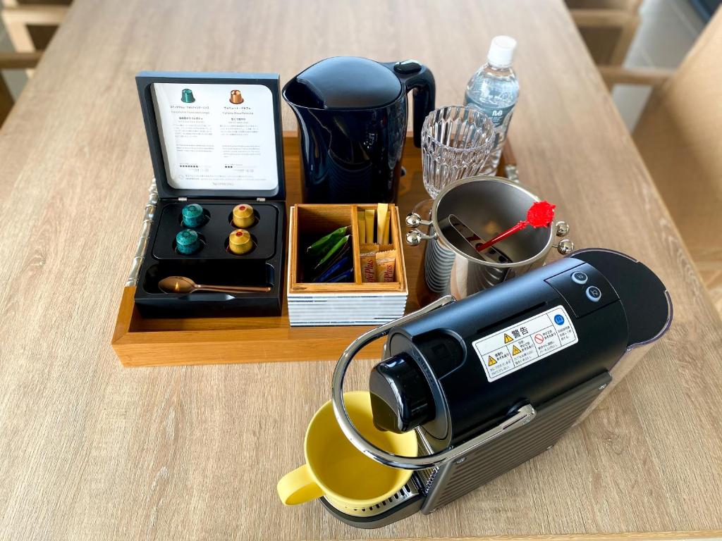 a table with a hair dryer and a cup on it at MB GALLERY CHATAN by THE TERRACE HOTELS in Chatan