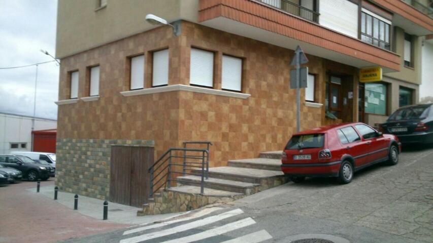 a red car parked in front of a building at Tercero Loft Susana in San Vicente de la Barquera