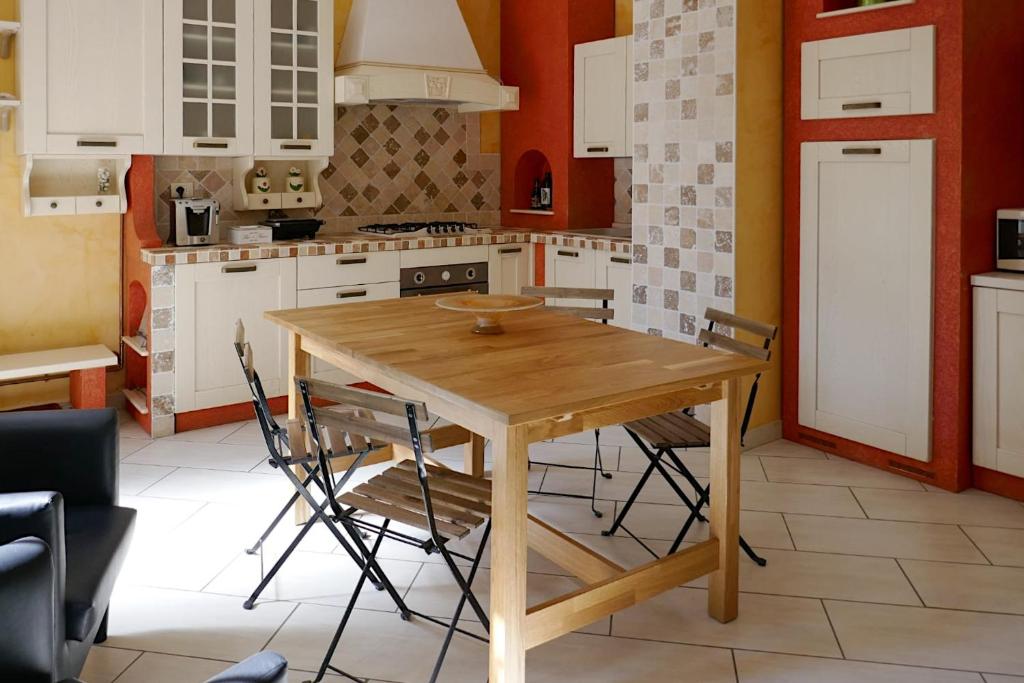 - une cuisine avec une table et des chaises en bois dans l'établissement ALASSIO Trilocale a 50mt dal mare, à Alassio