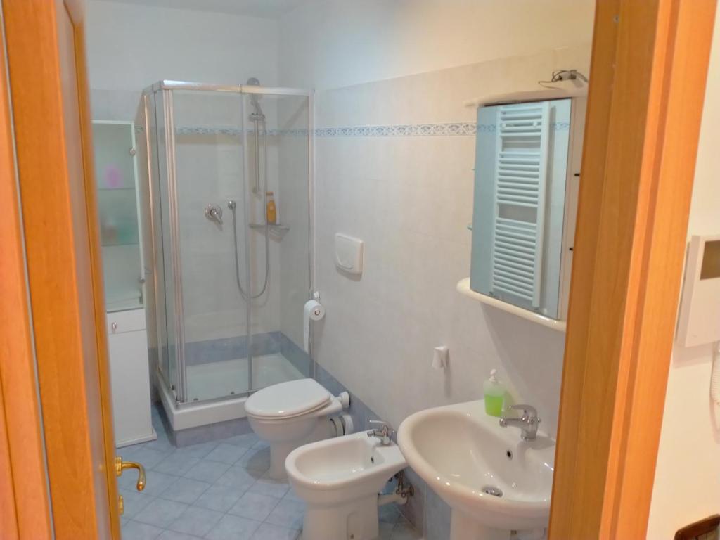a bathroom with a shower and a toilet and a sink at AiRPORT HOUSE ALEXANDER in Genoa