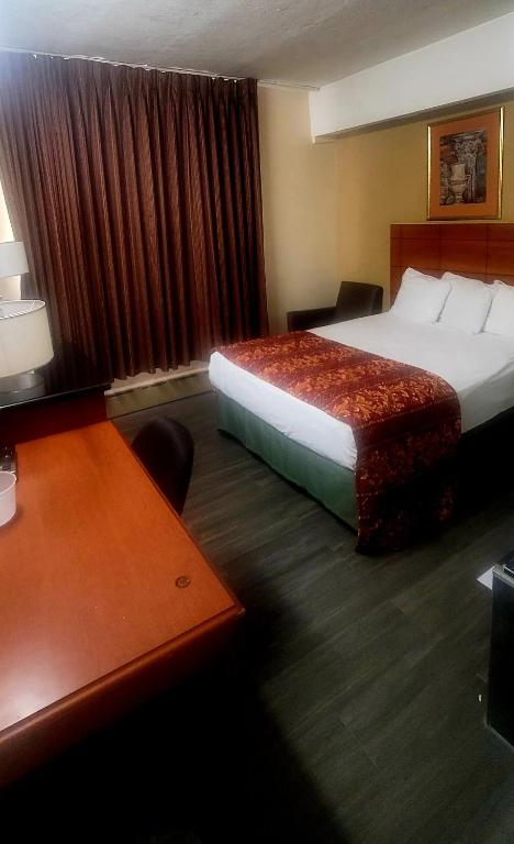 Postel nebo postele na pokoji v ubytování Jets Motor Inn