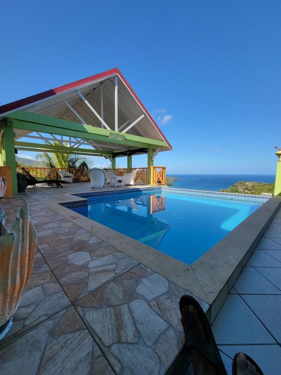 a swimming pool with a view of the ocean at Tropical Paradise View in Anse La Raye