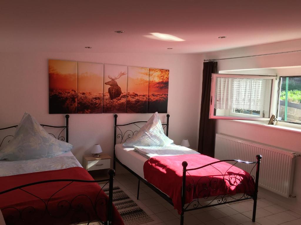 a bedroom with two beds and a window at Sebastiana's Monteur FeWo in Merzig