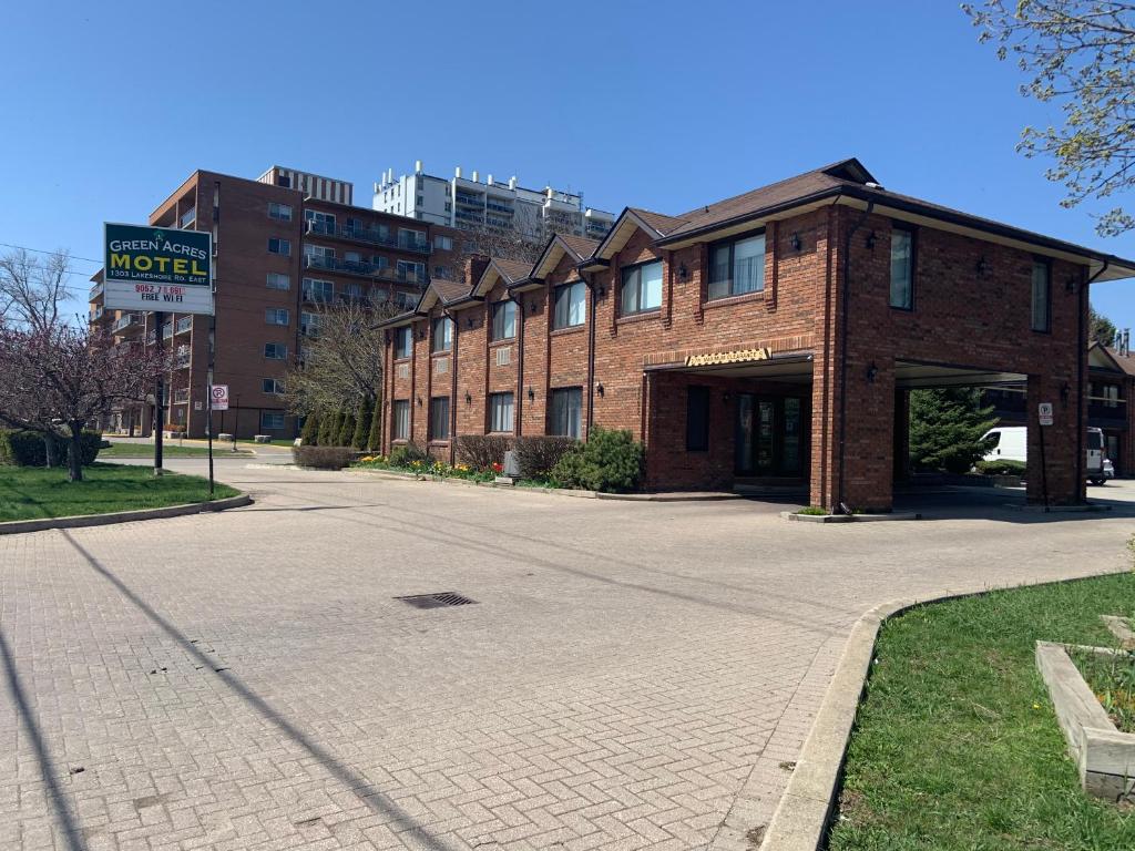 a brick building on a street in a city at Green Acres Motel in Mississauga