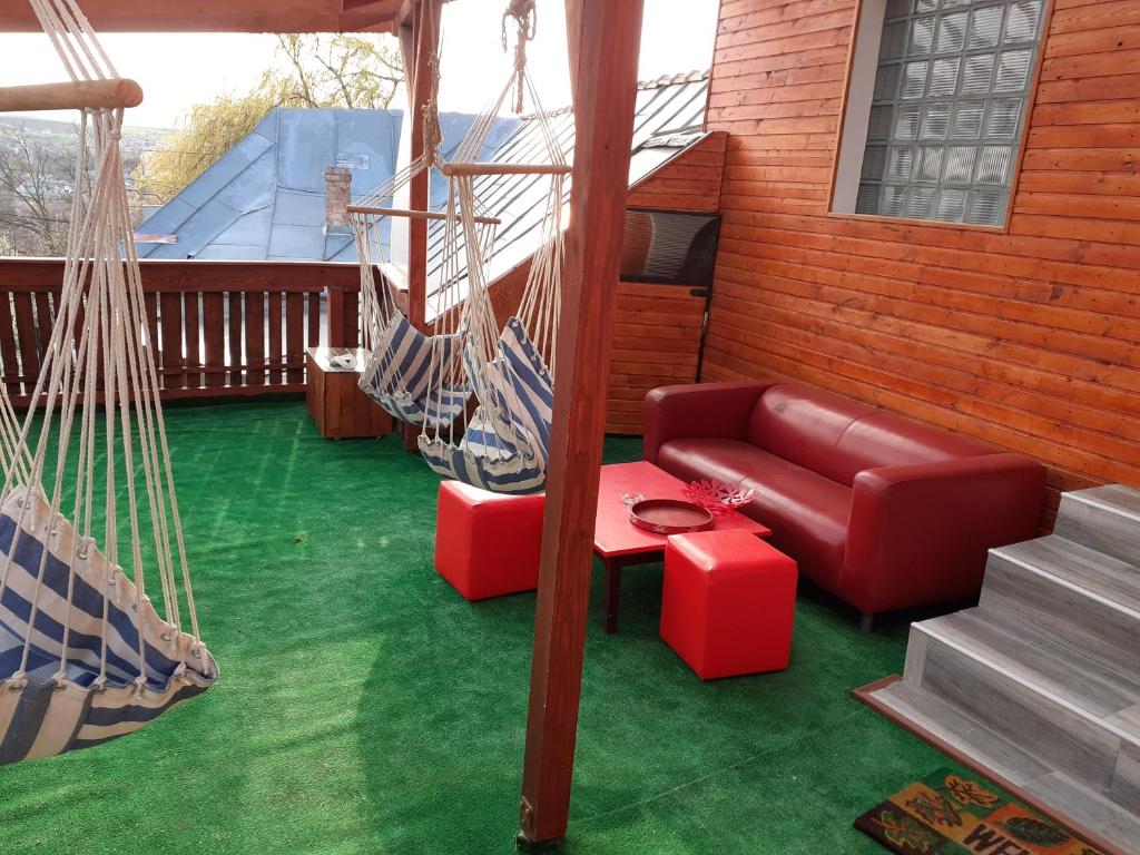a living room with a couch and a hammock at Casa ROOL in Turda
