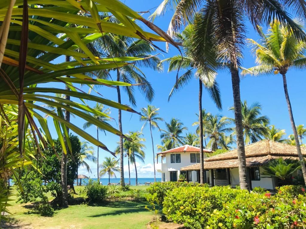 una casa en la playa con palmeras en Pousada Maraú en Marau