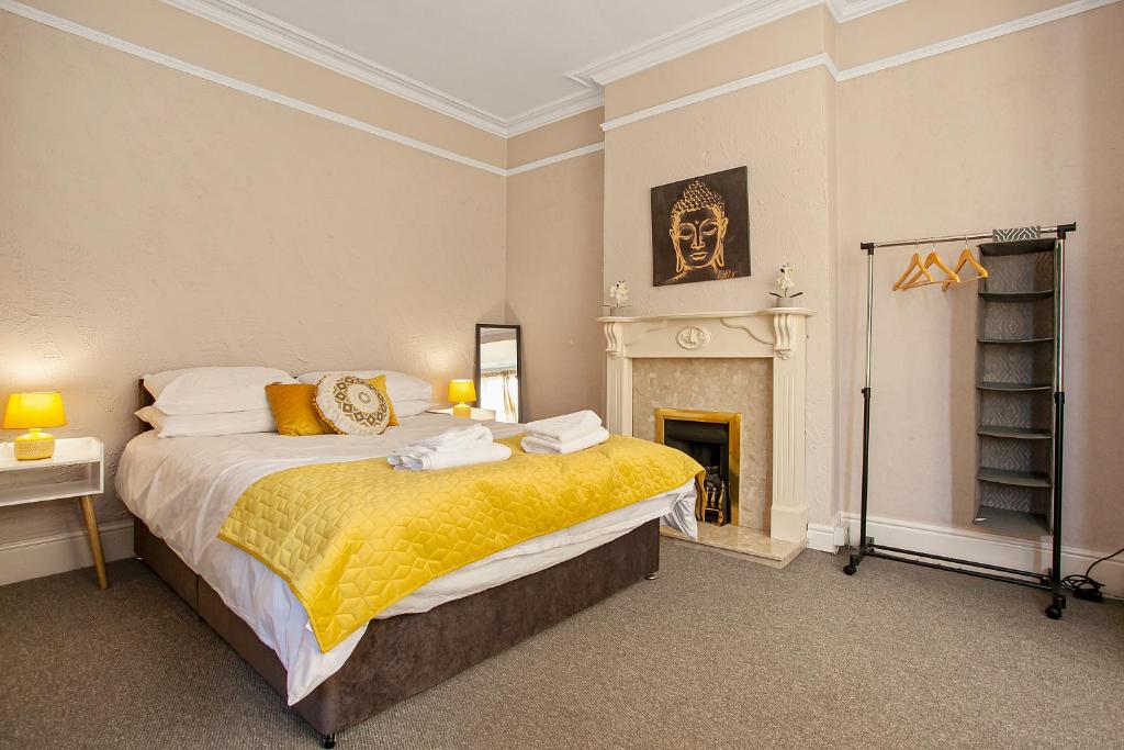 a bedroom with a large bed and a fireplace at Staywhenever NWT- 4 Bedroom House, King Size Beds, Sleeps 9 in Stoke on Trent