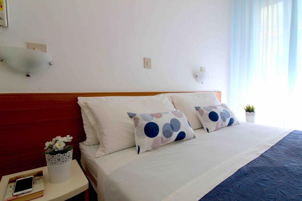 Postel nebo postele na pokoji v ubytování Hotel Kelly