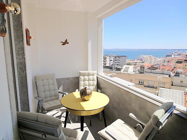 a room with a table and chairs on a balcony at Panteao - Lissabon Altstadt in Lisbon