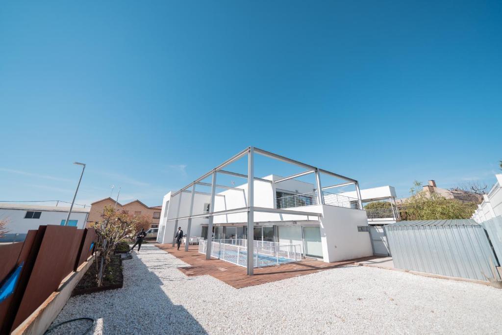 a large white building with a glass facade at Casa BlancadeNavarra in Fitero