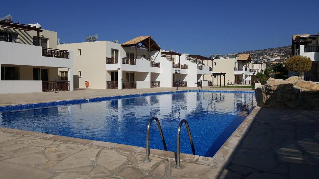 a large swimming pool in front of some buildings at Pleasant Studio apartment, Z4 in Vanessa Complex in Peyia