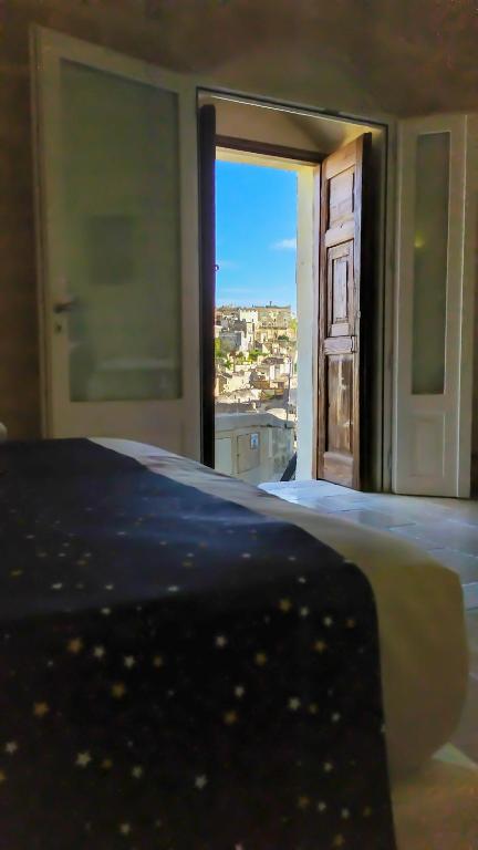 Postel nebo postele na pokoji v ubytování Loggia delle stelle