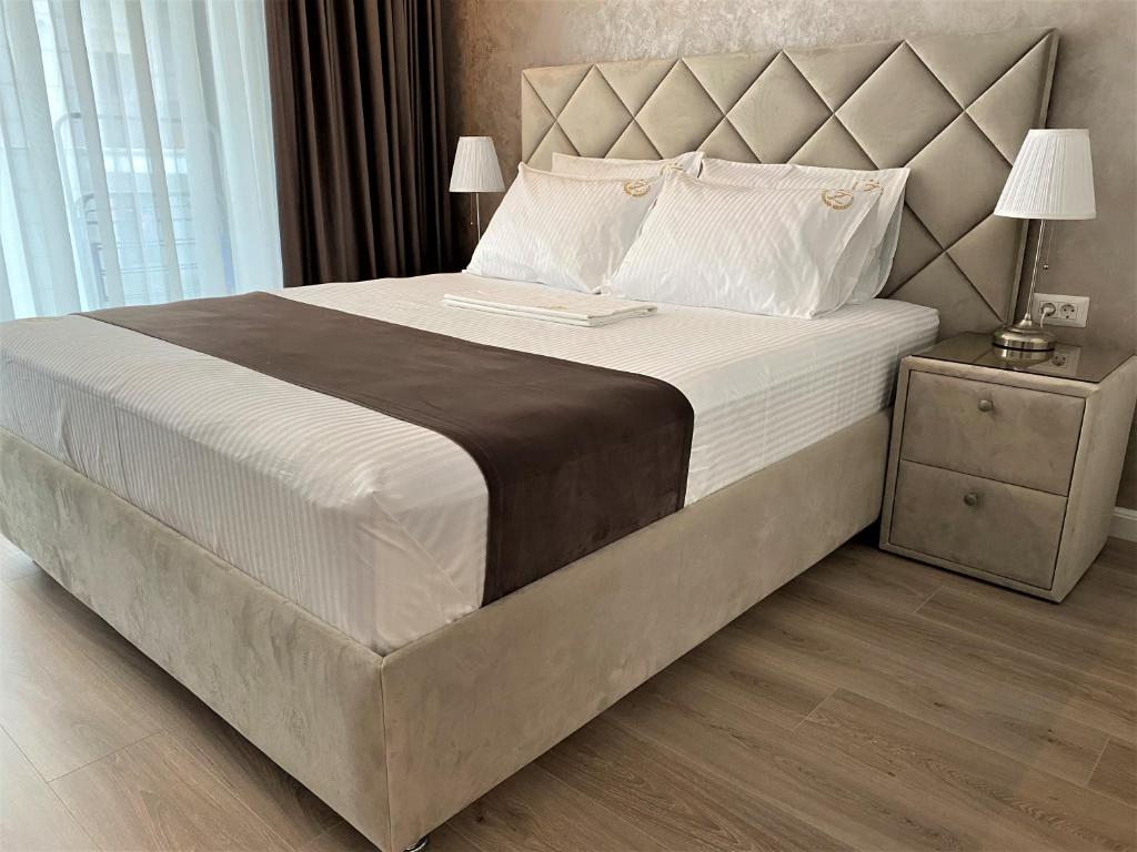 a bedroom with a large bed with a large headboard at Zeita din Bel-Air, Mamaia Nord in Mamaia