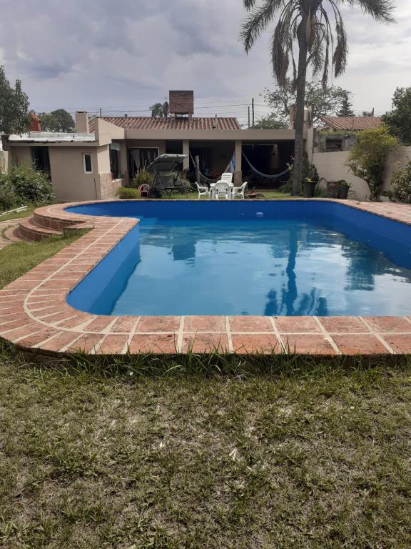 a swimming pool with a brick path around it at La casa deMarta in Córdoba