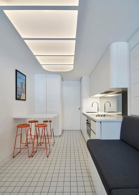 a kitchen with red chairs and a table and a counter at Hub 14 in Falls Creek