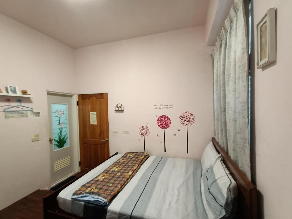 Postel nebo postele na pokoji v ubytování Ludao B&B