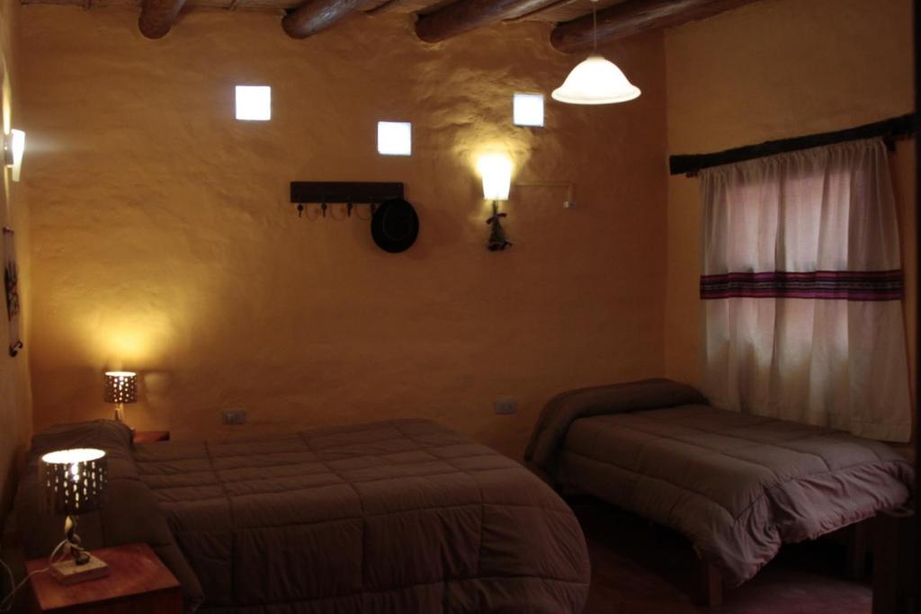 Postel nebo postele na pokoji v ubytování Hosteria La Estacion