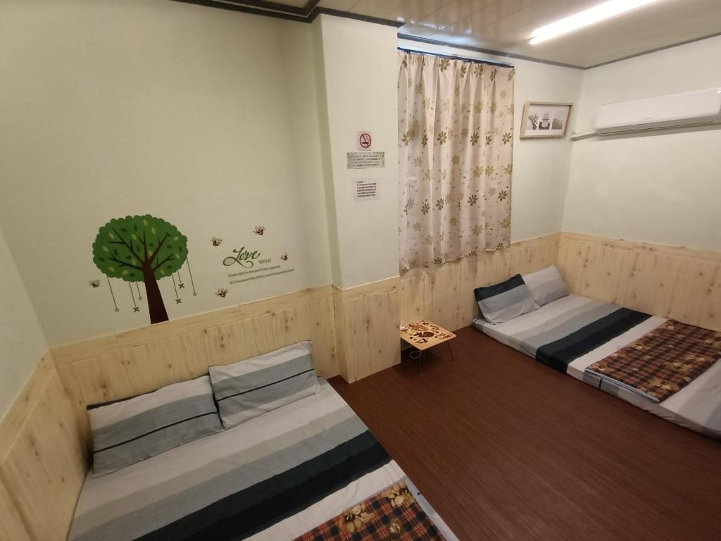 Postel nebo postele na pokoji v ubytování Ludao B&B