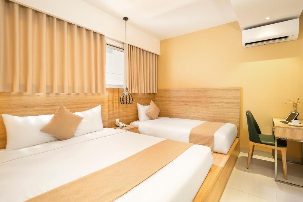 Postel nebo postele na pokoji v ubytování Bella Merry Hotel and Apartment