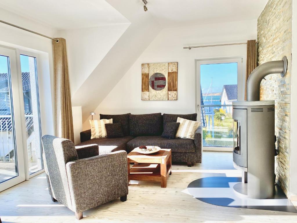 a living room with a couch and a fireplace at mönchgut living & spa in Gager