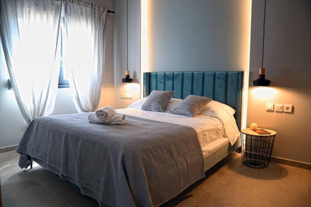 a bedroom with a bed with a towel on it at Havana 3 Luxury Pool and Sea Apartment in Gázion