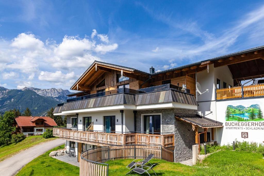 a house with a balcony on a mountain at Bucheggerhof in Schladming