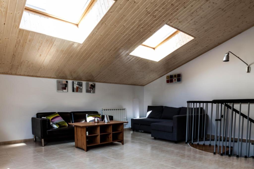 a living room with two couches and skylights at DUPLEX FRENTE A PISTAS in El Tarter