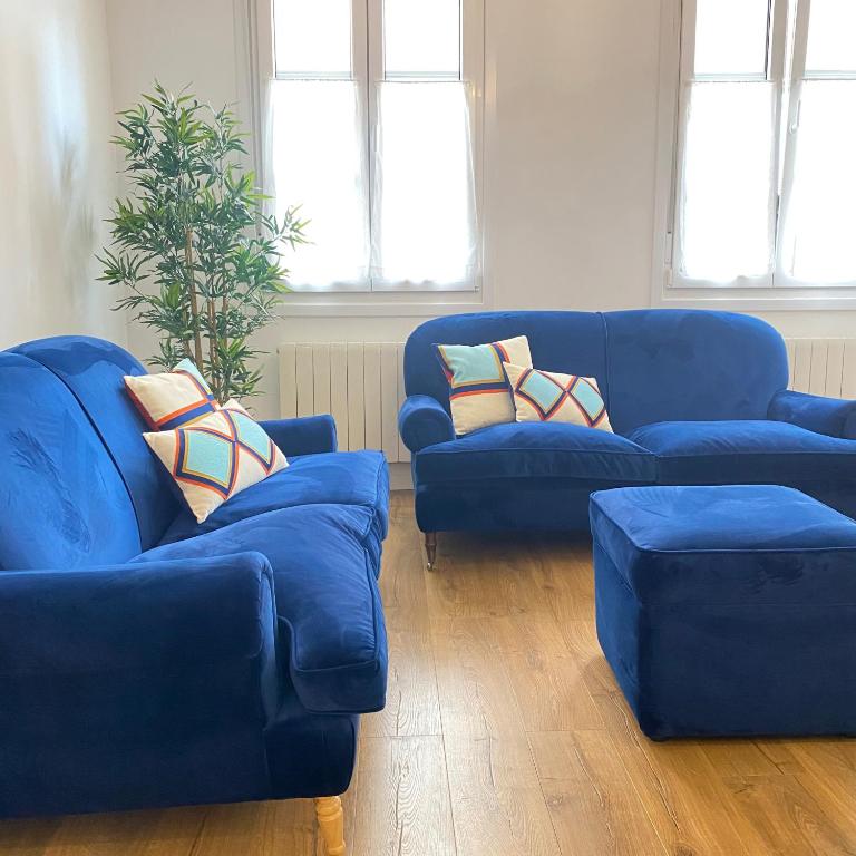 a living room with two blue couches and a plant at Old Town by Bilbao Living in Bilbao