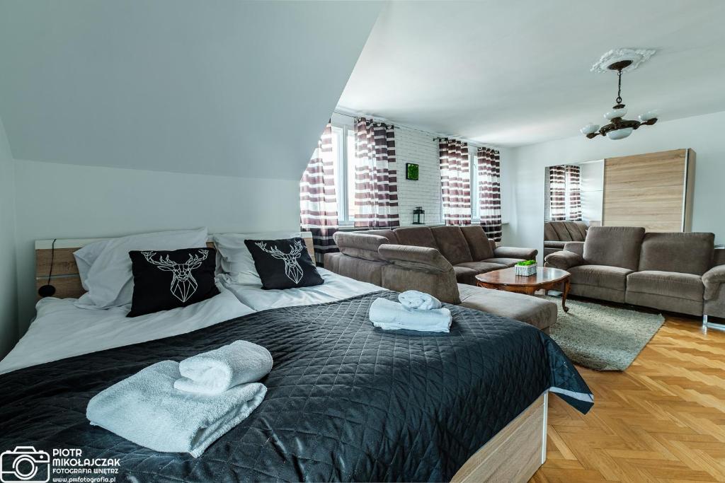 um quarto com uma cama grande e uma sala de estar em Apartament 27 z tarasem em Jelenia Góra