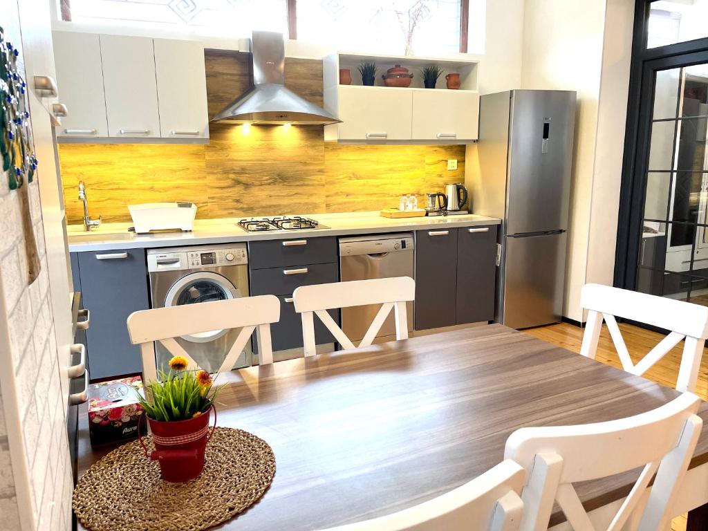 a kitchen with a table and chairs in a kitchen at Gabala Sweet Lounge in Gabala