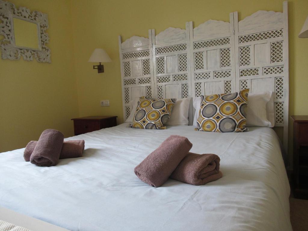 コラレホにあるCasa Sandra Oasis Tamarindoのベッドルーム1室(白いベッド1台、タオル2枚付)