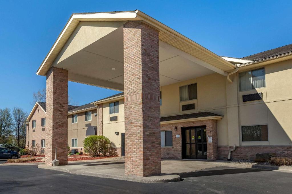 a large building with a brick pillar at Comfort Inn & Suites in Paw Paw