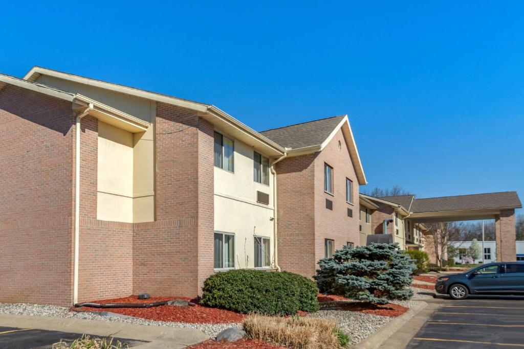 a house with a car parked in front of it at Comfort Inn & Suites in Paw Paw